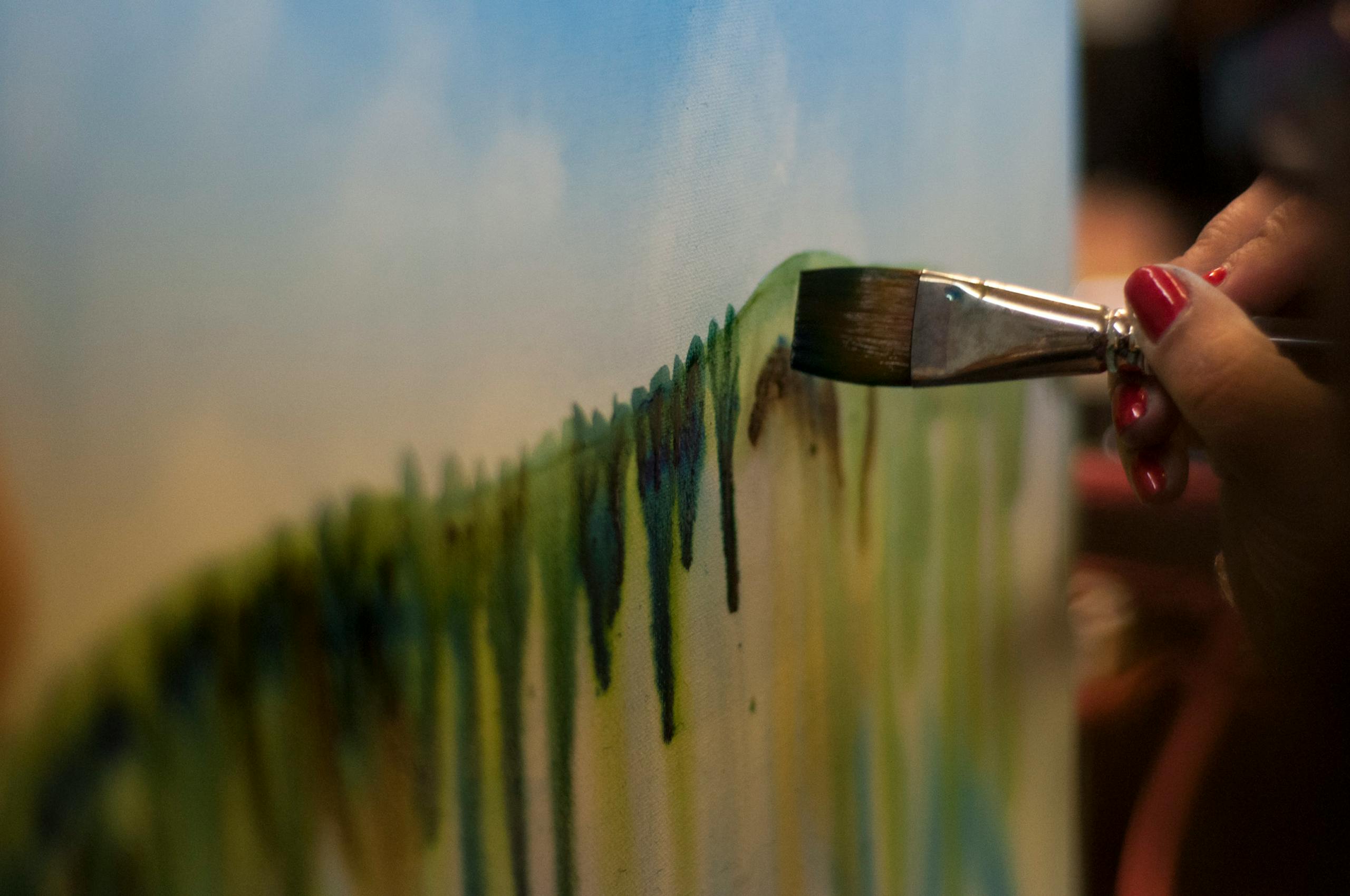 Close-up of a watercolor painting being created on canvas, showcasing artistic creativity.
