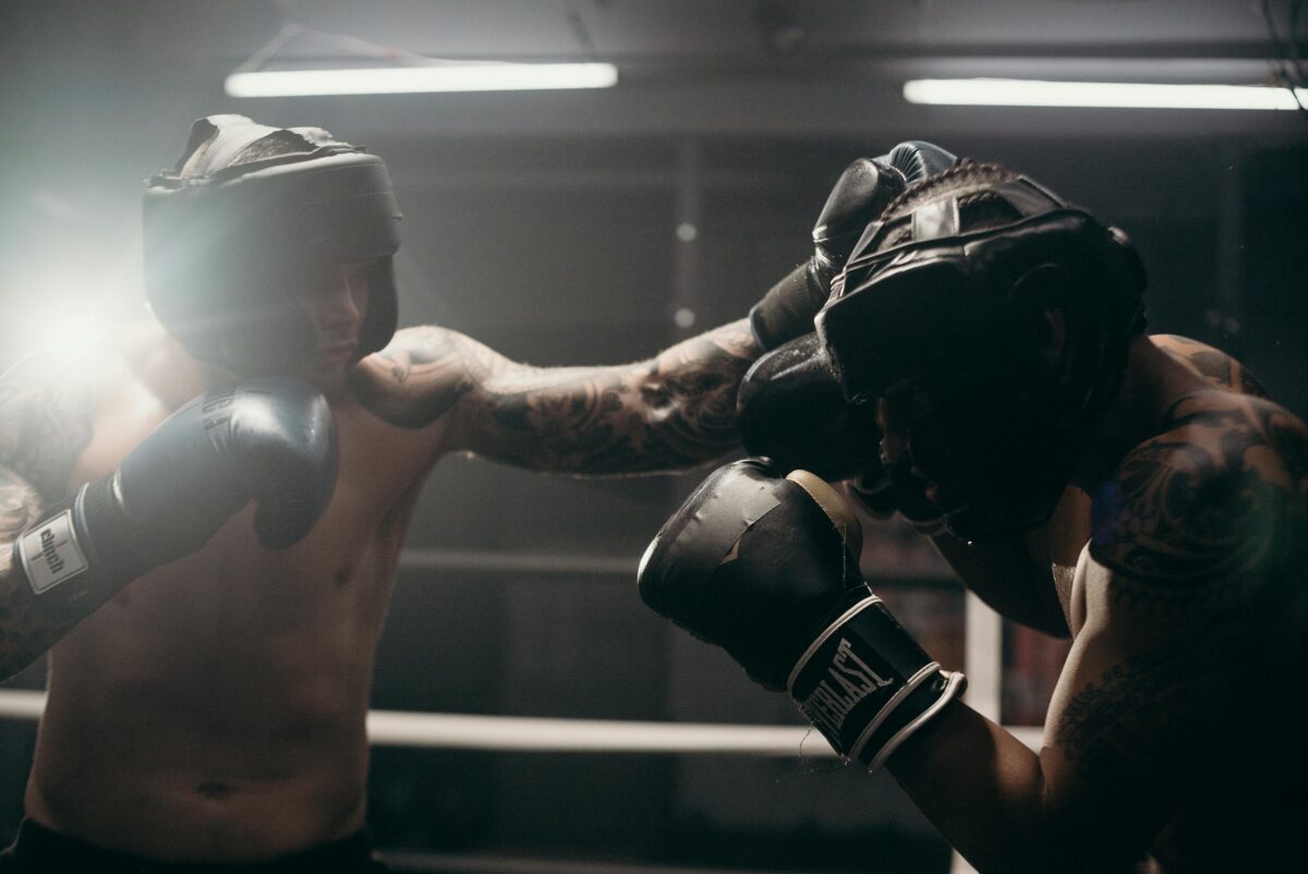 Professional boxers sparring in a gym, showcasing strength and technique.